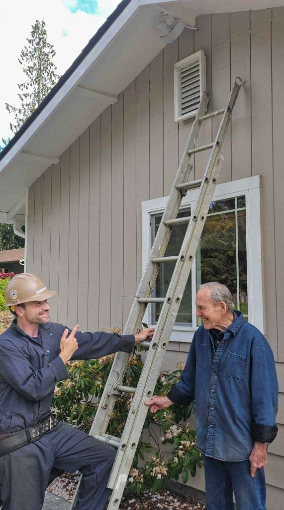 Damien and his father installing a home security system, representing FixIT’s family-focused, local tech service.